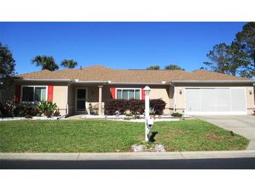 Charming home featuring well-maintained landscaping and an attached two-car garage at 13780 Sw 111Th Ave, Dunnellon, FL 34432