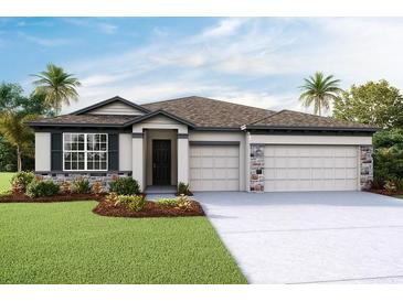 Charming one-story home with a three-car garage, stone accents, manicured lawn, and a well-maintained landscape at 3063 Canopy Oak Blvd, Wildwood, FL 34785