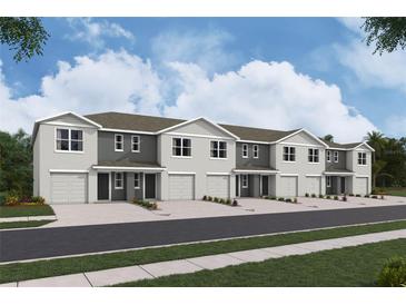Charming row of townhomes featuring attached garages and neutral-toned exteriors at 3282 Bertram Rd, Wildwood, FL 34785