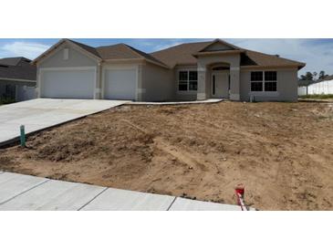 Charming single-story home with a two-car garage, neutral paint, and a lawn ready for landscaping at 71 Nw 42Nd Pl, Ocala, FL 34475