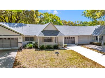 Charming single-story home featuring well-kept landscaping, a gray roof and a welcoming entrance at 8836 Sw 90Th Ln # B, Ocala, FL 34481