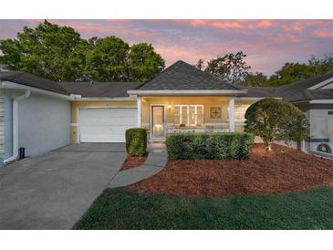 Charming single story home boasts a manicured lawn, attached garage, and covered entryway with space to sit at 9820 Sw 89Th Ter # B, Ocala, FL 34481