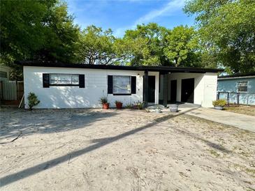 Charming single-story home featuring a clean white exterior with black shutters and a covered front entry at 5217 Montague Pl, Orlando, FL 32808