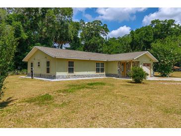 Charming single-story home with stone accents and attached garage at 13300 Ne 38Th Ave, Anthony, FL 32617