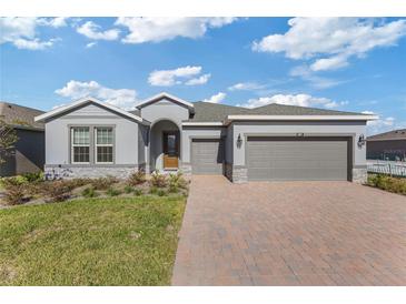 Charming single-Gathering home features a two-car garage and a brick-paved driveway at 5567 Nw 45Th Ln, Ocala, FL 34482