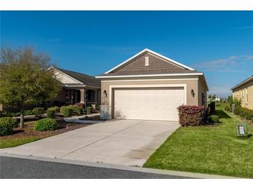 Charming single-Gathering home with a well-maintained lawn, two-car garage, and beautifully landscaped bushes at 9856 Sw 100Th Ter, Ocala, FL 34481
