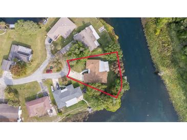 Aerial shot of a waterfront home surrounded by lush greenery and bordered by a tranquil river at 12180 Maple St, Dunnellon, FL 34432