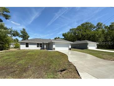 Charming single-story home featuring a well-manicured lawn and a long private driveway at 13269 Sw 112Th St, Dunnellon, FL 34432