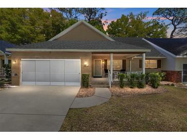 Charming single-story home with brick accents, a two-car garage, and a welcoming front porch at 8683 Sw 93Rd Ln # D, Ocala, FL 34481