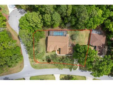 Aerial view of a single Gathering home with screened pool, set on a wooded lot at 9573 Sw 196Th Avenue Rd, Dunnellon, FL 34432