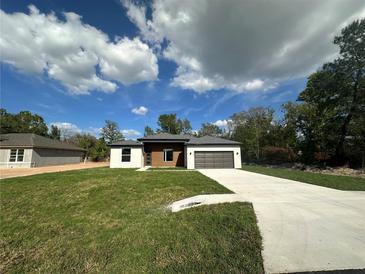 Charming single-story home featuring a gray roof, gray trim and an attached one car garage at 11555 Sw 59Th Ter, Ocala, FL 34476