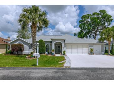 Charming single-story home with well-maintained landscaping, a three-car garage, and inviting curb appeal at 5195 Nw 21St Loop, Ocala, FL 34482