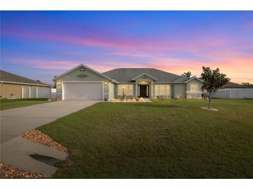 Charming single-story home with well-maintained lawn, neutral colors, and attached two-car garage at 9957 Sw 55Th Avenue Rd, Ocala, FL 34476
