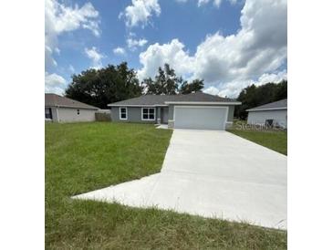 Charming single-story home with a well-maintained lawn and a spacious two-car garage at 13714 Sw 114Th Pl, Dunnellon, FL 34432