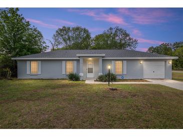 Charming single-story home with a well-manicured lawn and attached garage at 44 Pecan Run Dr, Ocala, FL 34472