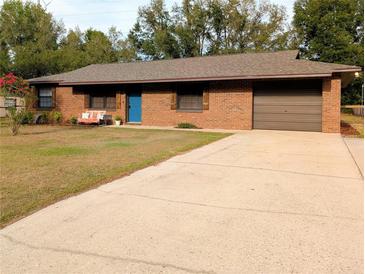 Charming single-story brick home with a well-maintained lawn and a spacious driveway at 4785 Ne 28Th Ter, Ocala, FL 34479