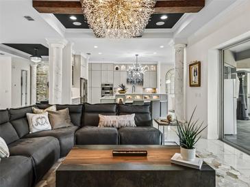 Living room flows into kitchen with a view of kitchen island at 7161 Ne 22Nd Court Rd, Ocala, FL 34479