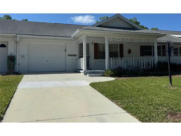Charming single-story home with a well-maintained front yard and a covered porch at 8680 Sw 94Th St # D, Ocala, FL 34481