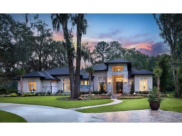 Stunning home showcasing manicured landscaping and a charming stone accented entry at 0000 Se 17Th Ct, Ocala, FL 34471