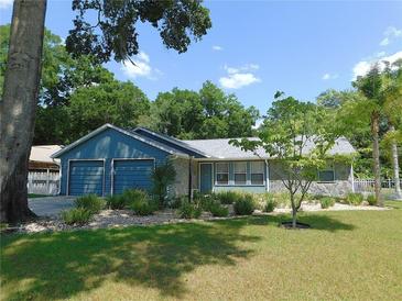Charming single-story home with a well-maintained lawn and mature landscaping at 1069 Se 57Th Ave, Ocala, FL 34480