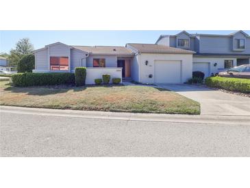 Charming single-story home featuring a well-maintained lawn, and an attached garage at 1951 Se 37Th Court Cir, Ocala, FL 34471