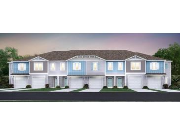 Charming townhome with a two-car garage, front lawn, and tasteful exterior finishes creating curb appeal at 3571 Se 37Th Ct, Ocala, FL 34480