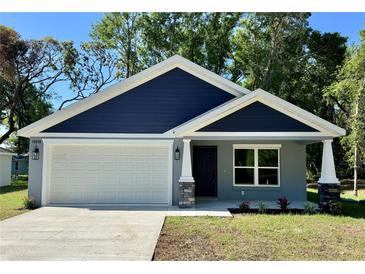 Charming single-Gathering home with a two-car garage and a well-manicured lawn at 13518 Sw 114Th Ln, Dunnellon, FL 34432