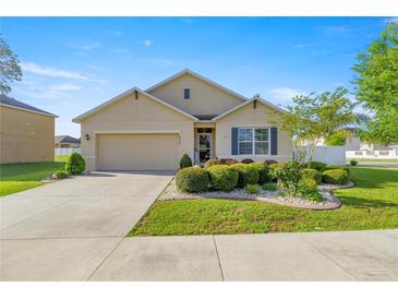 Charming single-story home featuring a well-manicured lawn and beautiful landscaping at 4398 Ne 29Th St, Ocala, FL 34470