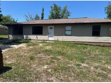 Cozy single-story home with light-colored siding and a well-lit front facade at 5871 Nw 1St St, Ocala, FL 34482