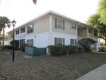 Two-story condo with green shutters, landscaping, and a quaint exterior at 8132 Fairways Cir # R103, Ocala, FL 34472