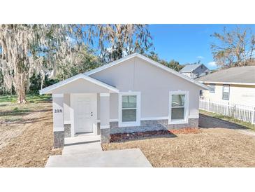 Charming single-story home with a bright, white exterior and lovely stone accents at 11415 Nw 15Th St, Ocala, FL 34482