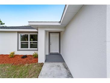 Close up showcasing the front door and attractive landscaping at 13344 Sw 112 Pl, Dunnellon, FL 34432