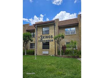 Well-maintained exterior view of a condo building featuring manicured landscaping at 2843 Ne 3Rd St # 109, Ocala, FL 34470