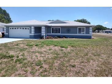Charming single-story home with a well-manicured lawn and a two car garage, presenting curb appeal at 10315 Sw 62Nd Terrace Rd, Ocala, FL 34476