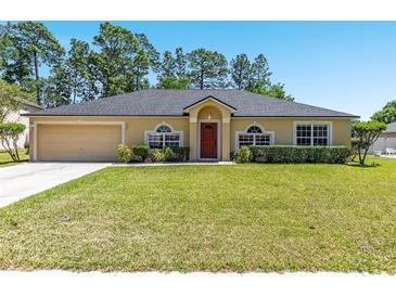 Charming one-story home with a well-manicured lawn and mature trees at 3011 Se 46Th Ave, Ocala, FL 34480