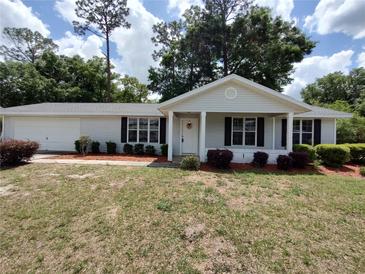 Charming single-story home with mature trees and attractive landscaping at 8045 Sw 108Th Loop, Ocala, FL 34481