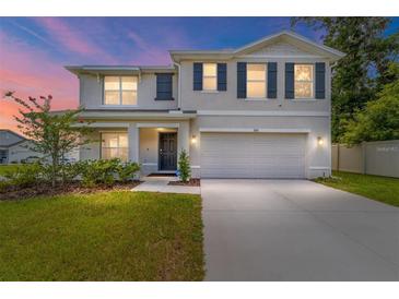 Charming two-story home with a well-manicured lawn, fresh landscaping, and a two-car garage at 11136 Se 69Th Ter, Belleview, FL 34420