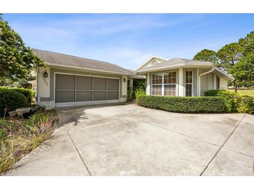 Charming home showcasing a well-maintained exterior, attached garage and mature landscaping at 15426 Sw 14Th Avenue Rd, Ocala, FL 34473