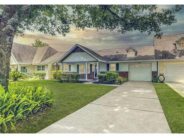 Charming single-story home with manicured lawn, mature trees, and an attached garage at 8351 Sw 93Rd Ln # D, Ocala, FL 34481