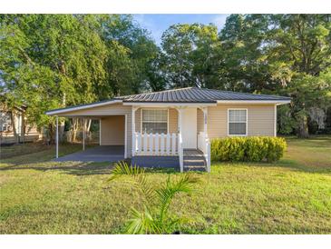 A charming home with a covered porch and carport offers a welcoming feel and practical features at 1309 Ne 33Rd St, Ocala, FL 34479