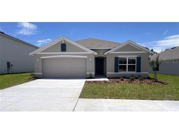 Charming single-story home featuring a well-maintained lawn, neutral paint, and a two-car garage at 15814 Se 101St Cir, Summerfield, FL 34491