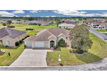 Inviting single-story home with a well-manicured lawn and a two-car garage in a serene neighborhood at 2369 Nw 53Rd Avenue Road, Ocala, FL 34482