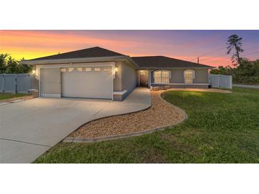 Charming single-story home featuring a two-car garage, landscaped yard and a concrete driveway at 2689 Sw 165Th Street Rd, Ocala, FL 34473