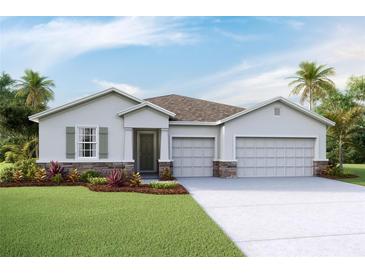 Charming single-story home features a two-car garage and manicured lawn at 3053 Canopy Oak Blvd, Wildwood, FL 34785