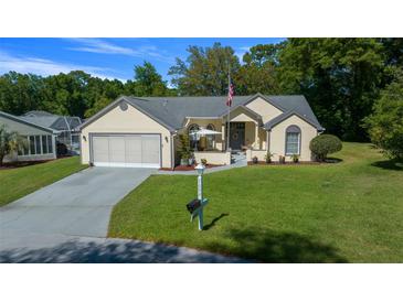 Charming single-story home with well-manicured lawn, attached garage, and inviting front porch at 7692 Sw 117Th Street Rd, Ocala, FL 34476
