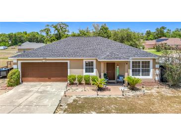 Charming single-story home featuring a well-manicured lawn and a welcoming front porch at 14978 Sw 46Th Cir, Ocala, FL 34473