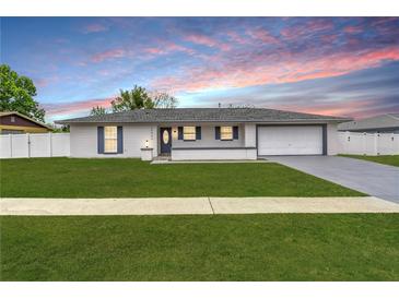 Charming single-story home featuring a manicured lawn and a classic color scheme at 15044 Sw 35Th Avenue Rd, Ocala, FL 34473