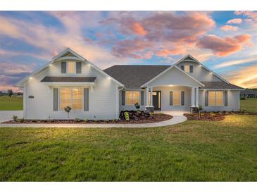 Charming single-Gathering home boasts manicured landscaping, a curved walkway, and a beautiful exterior at 1784 Nw 85Th Loop, Ocala, FL 34475