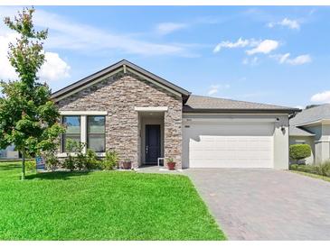 Charming one-story home featuring a stone facade and well-maintained landscaping at 3840 Se 6Th Ave, Ocala, FL 34480
