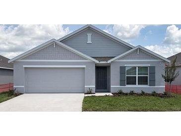 Charming single-story home features a two-car garage, well-maintained lawn, and stylish gray exterior at 4691 Sw 88Th Ln, Ocala, FL 34476